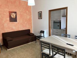 a living room with a couch and a table at Luna Apartment in Rimini
