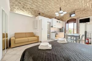 a living room with a couch and a table at La Castellana in Monte SantʼAngelo +13 photos