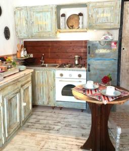 an old kitchen with a stove and a table at The Cottage by the lake 1 in San Maurizio dʼOpaglio +19 photos