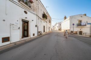 an empty street with a person walking down the street at La Castellana in Monte SantʼAngelo