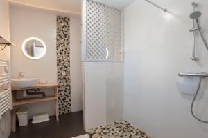 a bathroom with a shower and a toilet and a sink at Le Chalet des Retrouvailles in Sers +21 photos