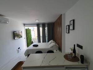a bedroom with a bed and a large window at BlumLuxury Apartment in San Bartolomé +25 photos