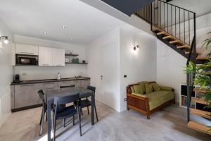 a kitchen and dining room with a table and a couch at Lo Sarvanot in Bernezzo