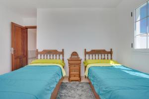 two beds sitting next to each other in a bedroom at Casa Oasis in Tías +18 photos