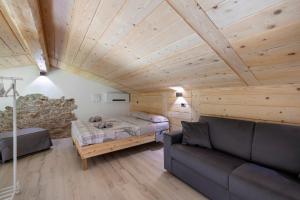 a living room with a bed and a couch at Lo Sarvanot in Bernezzo