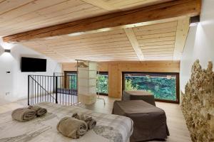 a bedroom with a large bed in a room with wooden ceilings at Lo Sarvanot in Bernezzo