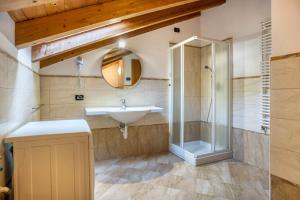 a bathroom with a sink and a shower at Casa Mirtillo Batistei in Molveno +23 photos