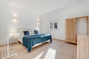 a bedroom with a bed with a blue blanket at La Casa del Caballo in Adeje +20 photos