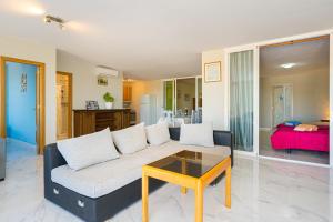 a living room with a couch and a table at Casa Meli in Finestrat