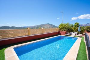 a swimming pool on the roof of a house at Casa Meli in Finestrat