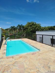 a swimming pool on top of a patio with at Cachoeira Paulista Espaço Cassicay in Cachoeira Paulista