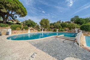 a swimming pool in a villa with a tree at Villa Valentina in Carvoeiro