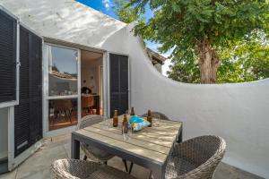 a wooden table with chairs on a patio at Villa Valentina in Carvoeiro