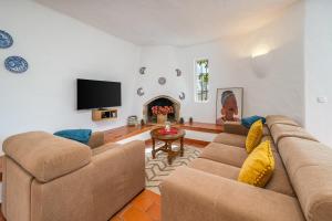 a living room with two couches and a tv at Villa Valentina in Carvoeiro