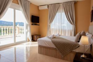 a bedroom with a bed and a large window at Paulina in Jávea +31 photos