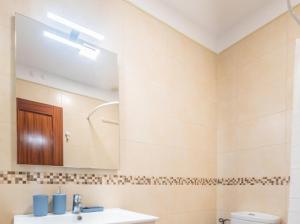 a bathroom with a sink and a mirror at Costa Fortuna in Poris de Abona +22 photos