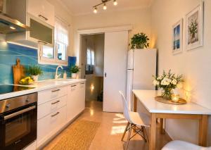 a kitchen with a table and a white refrigerator at Jenny Apartment in Gaios