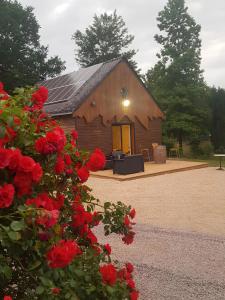 a house with red roses in front of it at Le Ty Gîte - Sud Morbihan in Théhillac