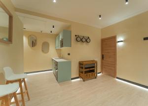 a kitchen with a refrigerator and a table and chairs at Das Carretas in Madrid