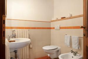 a bathroom with a sink and a toilet at Appartamento il Melo in Grassina +14 photos