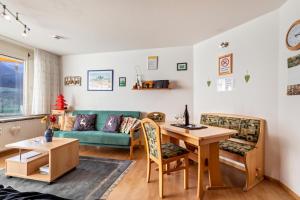 a living room with a couch and a table at Studti 134 in Beuren +10 photos