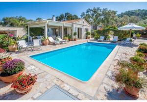a swimming pool in the backyard of a house at Villa Aloni in Lákka