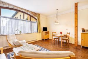 a living room with a table and a couch at Gemütliches Apartment In Lohmen in Lohmen