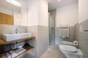 a bathroom with a sink and a toilet and a shower at Haus Mader 1 in Riscone +16 photos