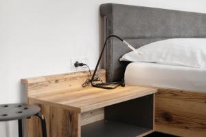 a bedroom with a bed and a desk with a lamp at Haus Mader 1 in Riscone