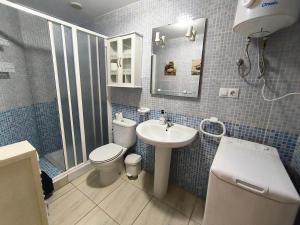 a bathroom with a toilet and a sink and a shower at Apartamento el Carmen in El Cotillo