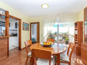 a kitchen and dining room with a table and chairs at Apartment Coco Golf by Interhome in Sant Jordi