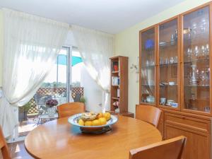 a dining room table with a bowl of fruit on it at Apartment Coco Golf by Interhome in Sant Jordi