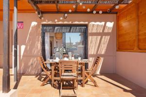 a wooden table and chairs on a patio at Sweet Home Majanicho in Majanicho