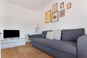 a living room with a couch and a flat screen tv at Sweet Home Majanicho in Majanicho