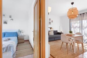 a room with a bed and a table and a couch at Sweet Home Majanicho in Majanicho +36 photos