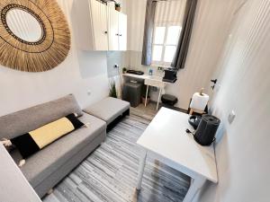 a living room with a couch and a table at aeolian blu 3 in Parikia