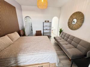 a bedroom with a large bed and a couch at aeolian blu 3 in Parikia