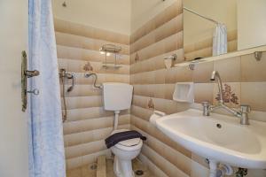 a bathroom with a toilet and a sink at S8 room in Nikiana
