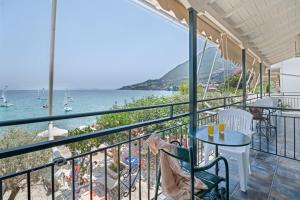 a balcony with a table and chairs and the ocean at S8 room in Nikiana