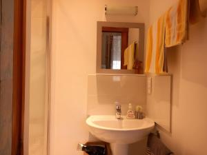 a bathroom with a white sink and a mirror at Les Chambres Des Chtis in Abbeville