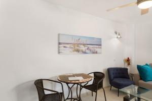 a living room with a table and chairs and a couch at Casa Paula - 25 in Arinaga