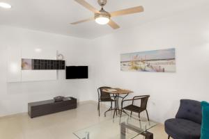 a living room with a ceiling fan and a table at Casa Paula - 25 in Arinaga