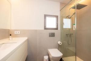 a bathroom with a shower and a toilet and a sink at Ca Na Tonina Ref 7000 in S'Illot