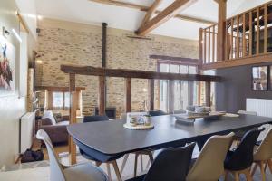 a dining room with a table and chairs at Le Ranch Des Ours in Champsac