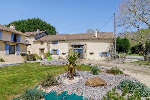 an exterior view of a house with a yard at Le Ranch Des Ours in Champsac