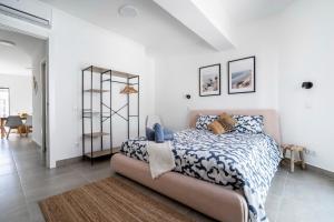 a bedroom with a bed with a blue and white comforter at Ptm Arade View Penthouse T3 Duplex in Portimão