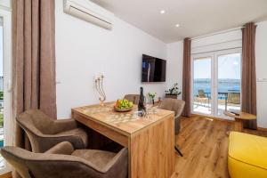 a living room with a dining room table and chairs at Apartments San in Dramalj