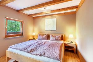 a bedroom with a bed with two lamps on tables at Connerhof Todtnauberg in Todtnau