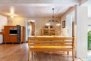a dining room with a bench and a kitchen at Connerhof Todtnauberg in Todtnau