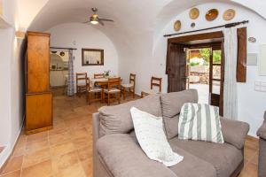 a living room with a couch and a table at Villa moli de ca n'orell in Santanyi